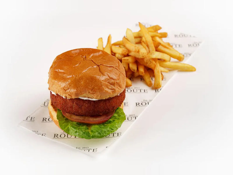 Vegan kofte burger in a brioche bun with vegan garlic mayo and skin on chips at Cafe Route