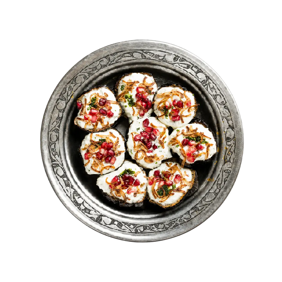 Rolled aubergine salad topped with pomegranate and herbs, vegan cold side at En Route