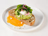 Avo Feta on sourdough toast with poached eggs, pickled onion and crumbled mint feta at Cafe Route