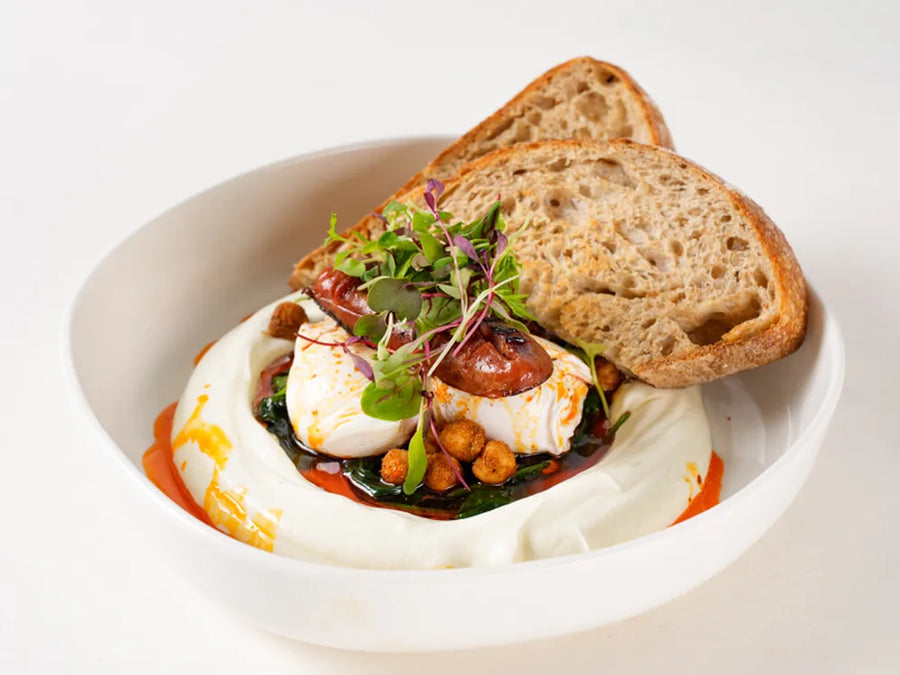 Mediterranean cilbir with poached eggs on garlic yoghurt, spinach, chickpeas and chilli butter