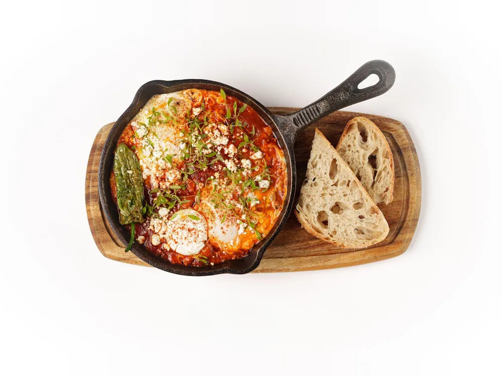 Shakshuka skillet with eggs, labneh, feta and padron pepper served with sourdough at Cafe Route