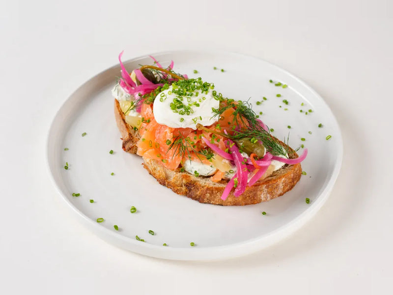 Smoked salmon on sourdough with poached eggs, herbed cream cheese, capers and dill at Cafe Route