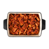 Honey harissa chicken in a dark serving dish, En Route lunch box main