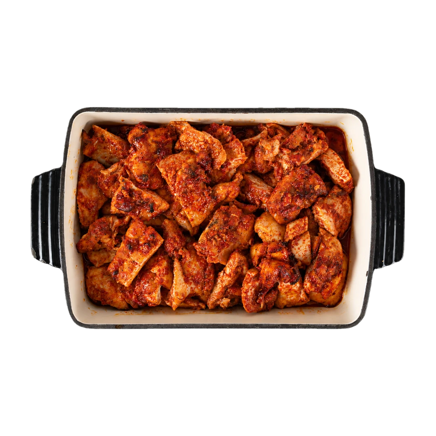 Honey harissa chicken in a dark serving dish, En Route lunch box main