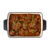 Medi birria beef in a dark serving dish, En Route lunch box main