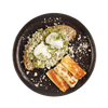 Plated dish with toast, cheese, and green spread on a black plate